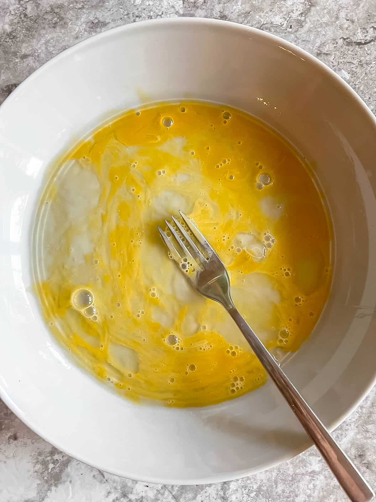 Egg scrambled in bowl.