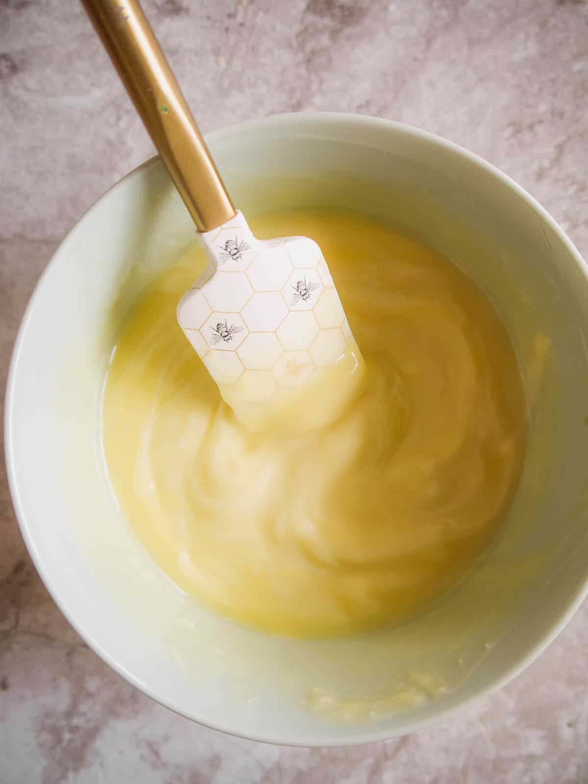 Melted white chocolate and butter in a bowl.