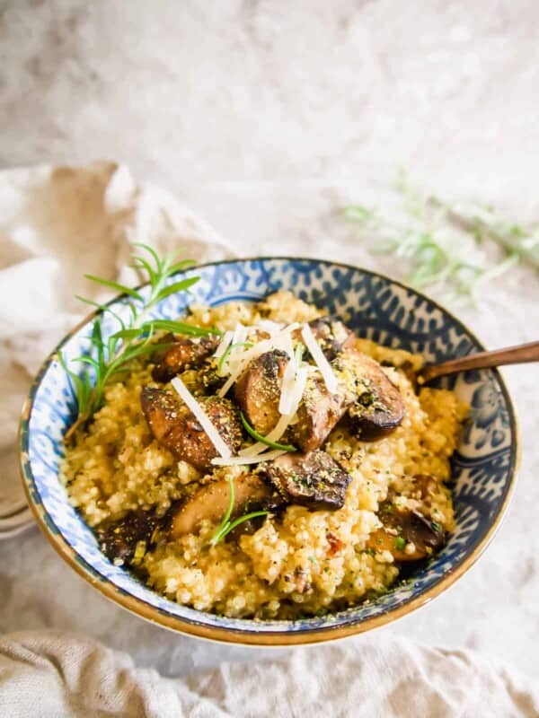 Mushroom Quinoa Risotto in a bowl with Parmesan on top.