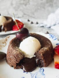 Gluten-free Molten Chocolate Espresso Lava Cakes with molten center falling out and ice-cream on top.