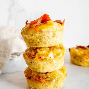 Sweet Potato Egg Cups with Bacon stacked on top of each other.