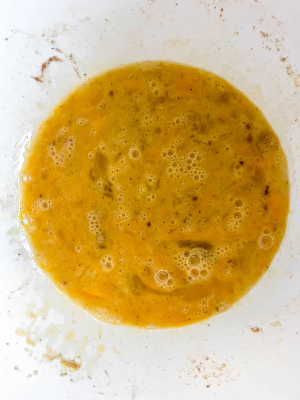 The eggs and seasoning mixed together in a bowl.