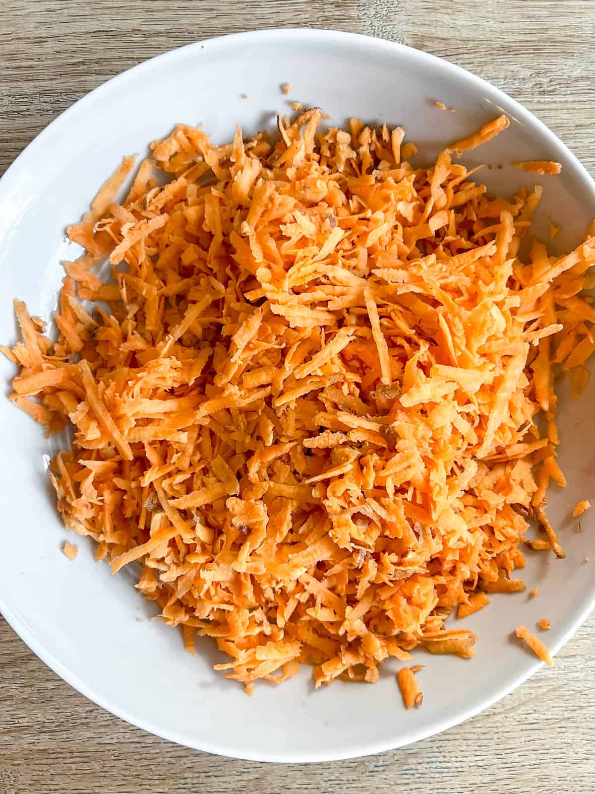 Shredded sweet potato in a bowl.