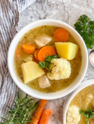 Paleo chicken soup in a bowl on a table.