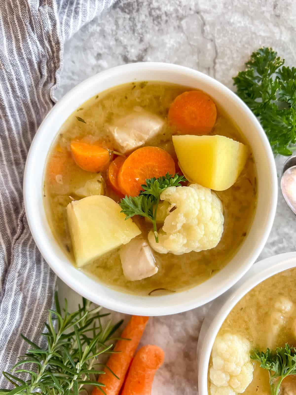 Paleo chicken soup in a bowl on a table.