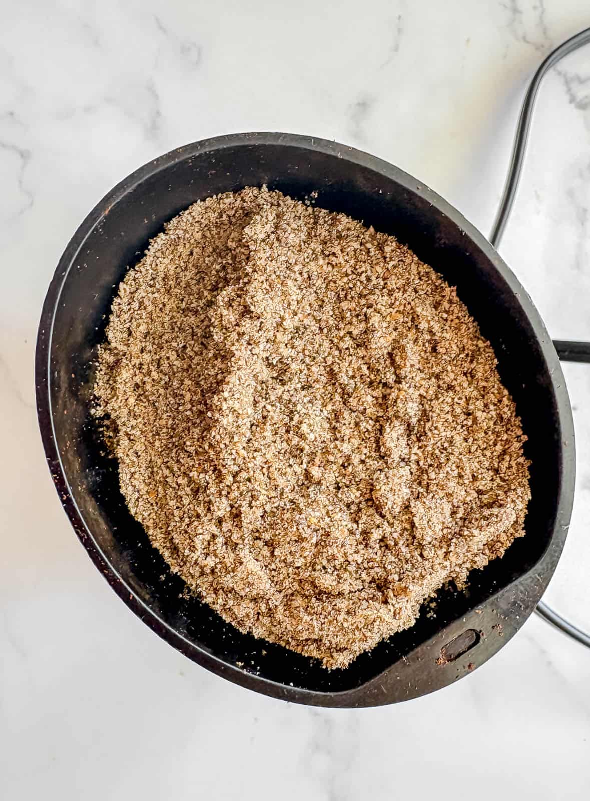 Grinding chia seeds in a coffee grinder.