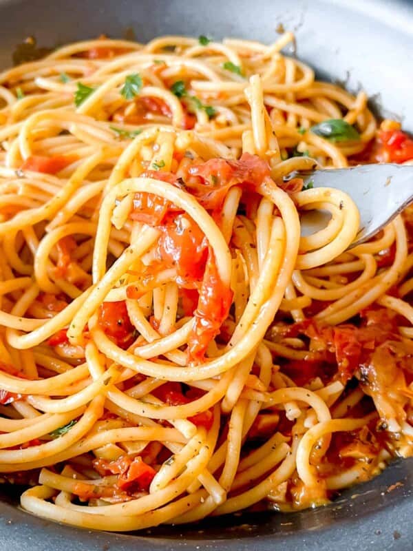 Cherry tomato sauce with garlic mixed into spaghetti.