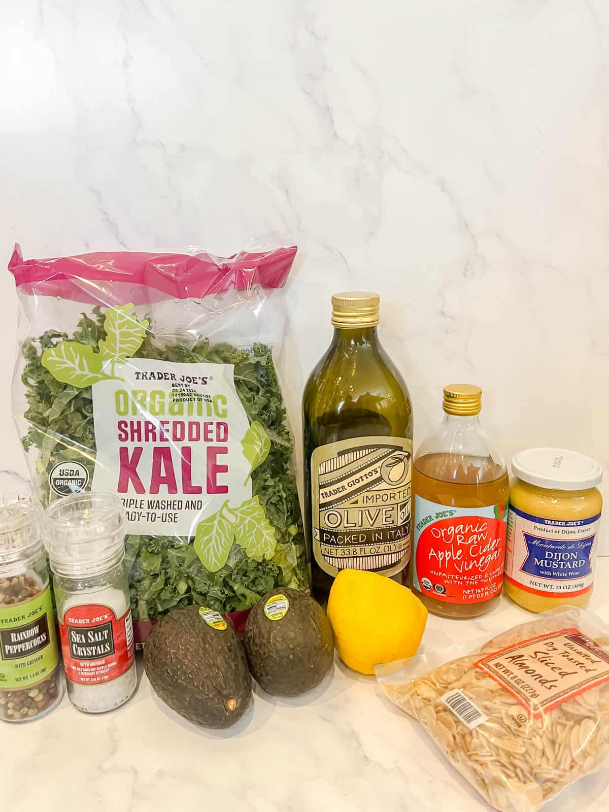 Ingredients needed to make salad with kale and avocado.