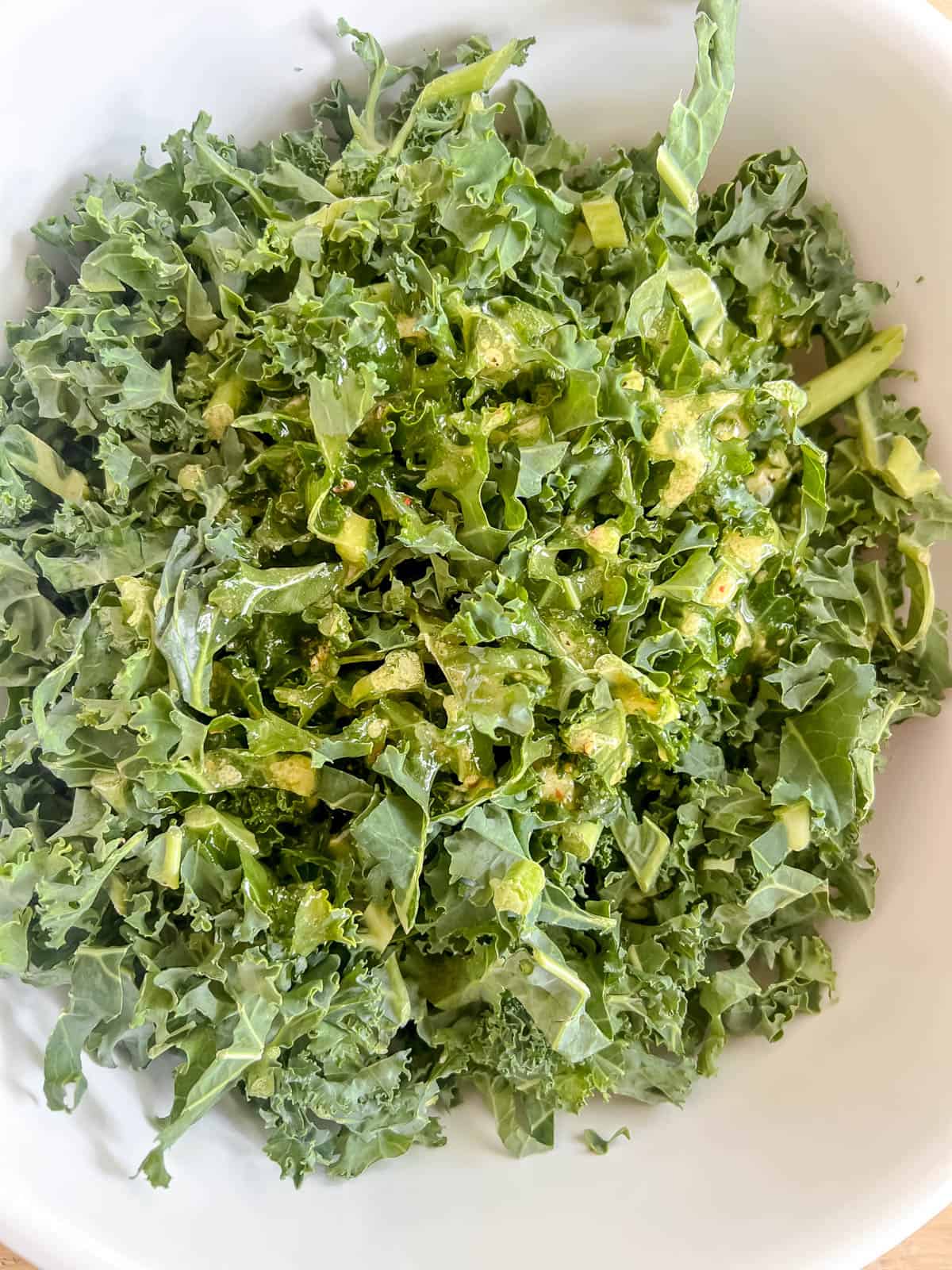 Kale with dressing in a bowl.