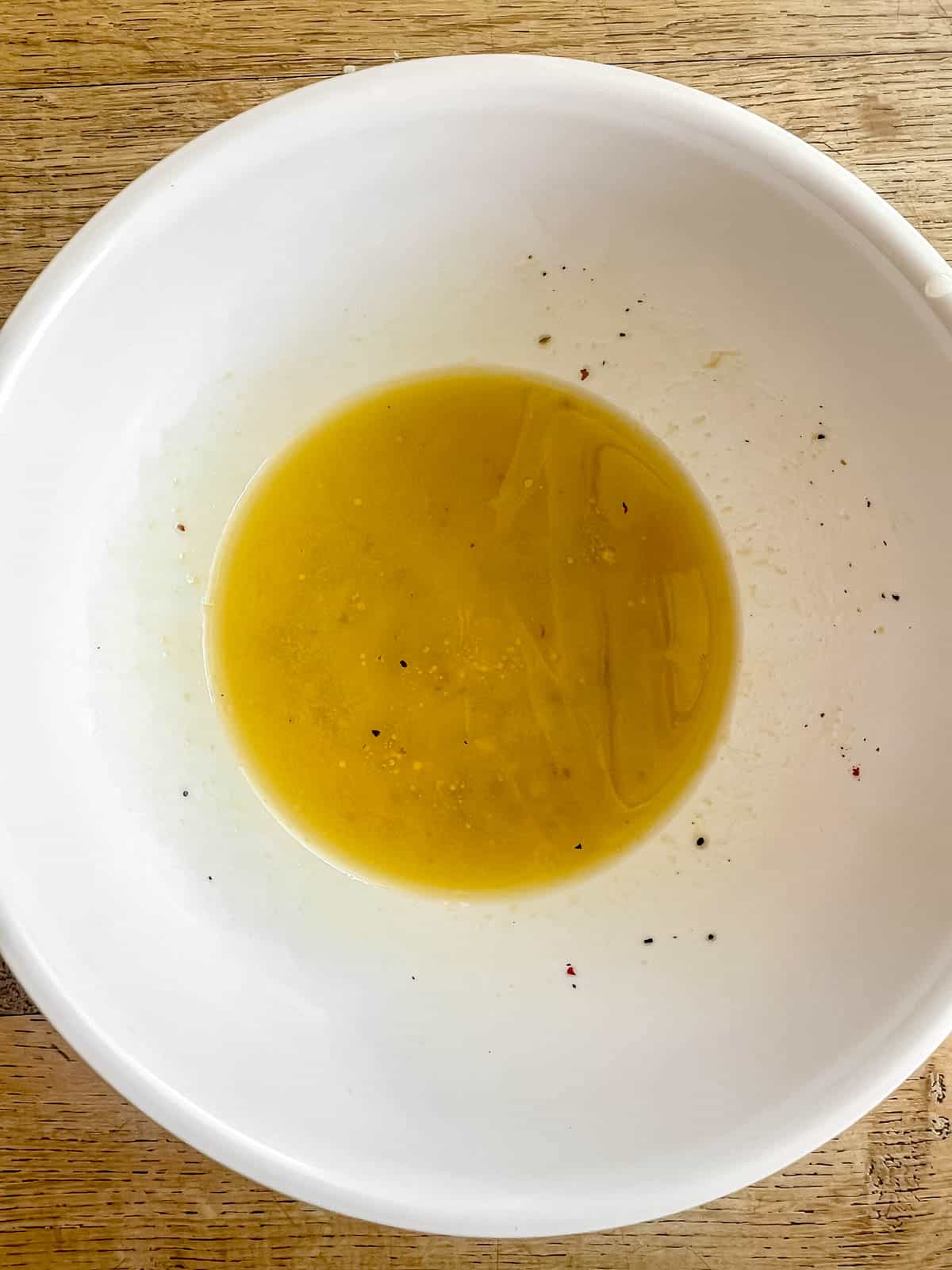 Lemon mustard salad dressing for kale salad in a bowl.
