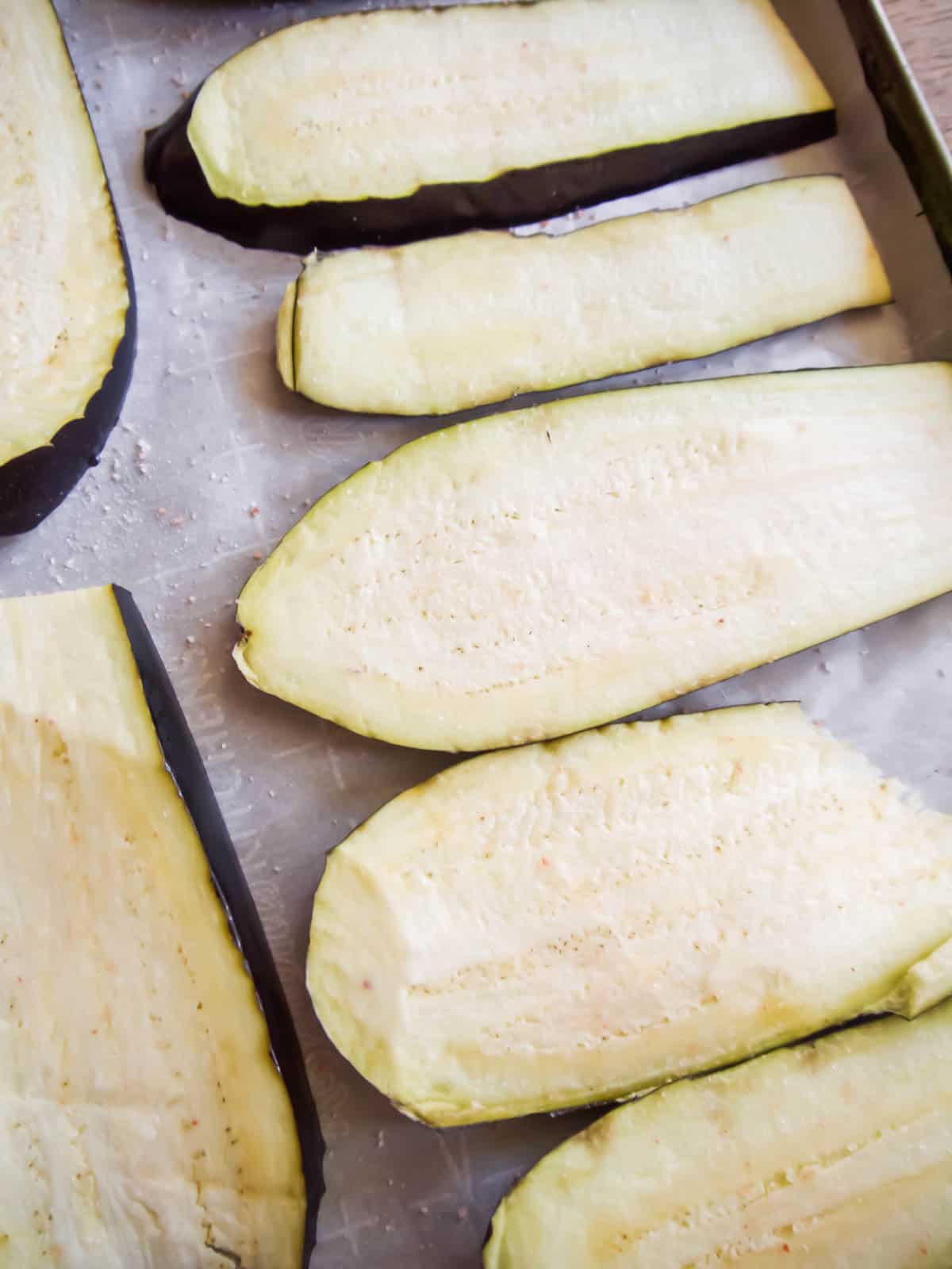 Sliced eggplant that is salted.