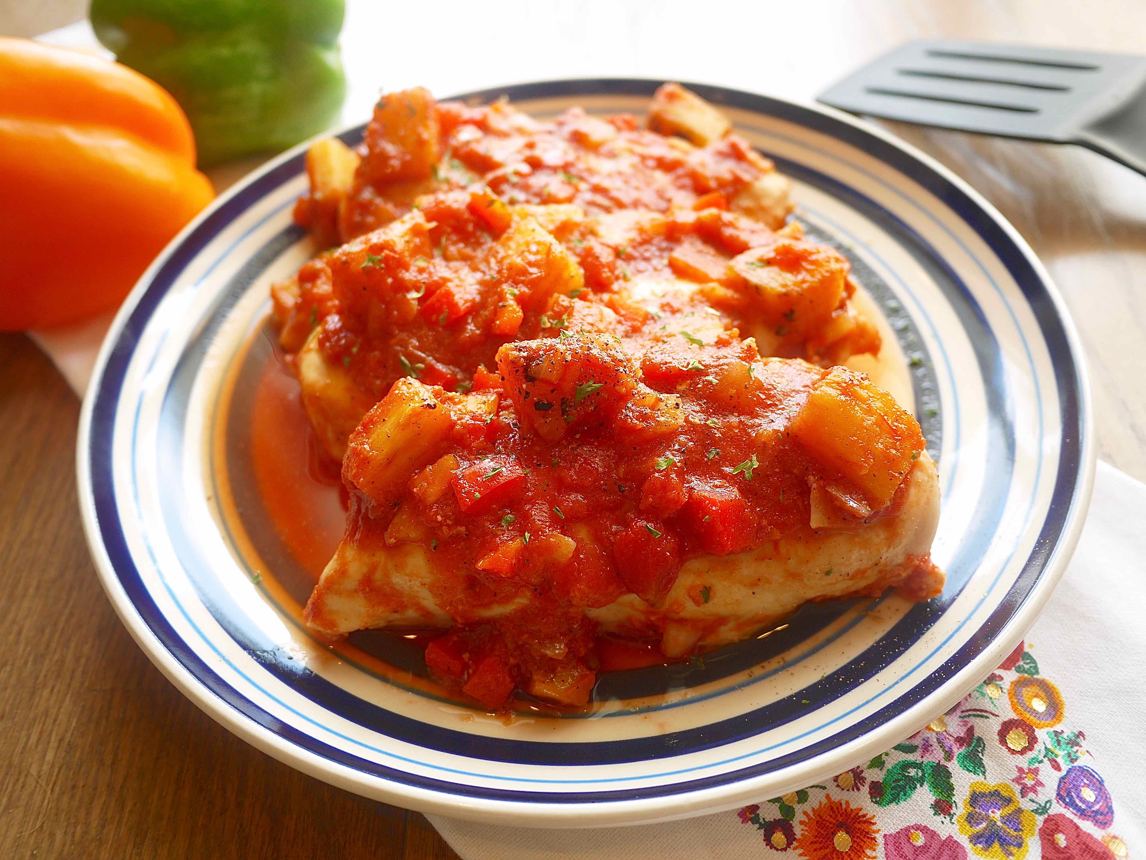 Chicken topped with pineapple salsa.