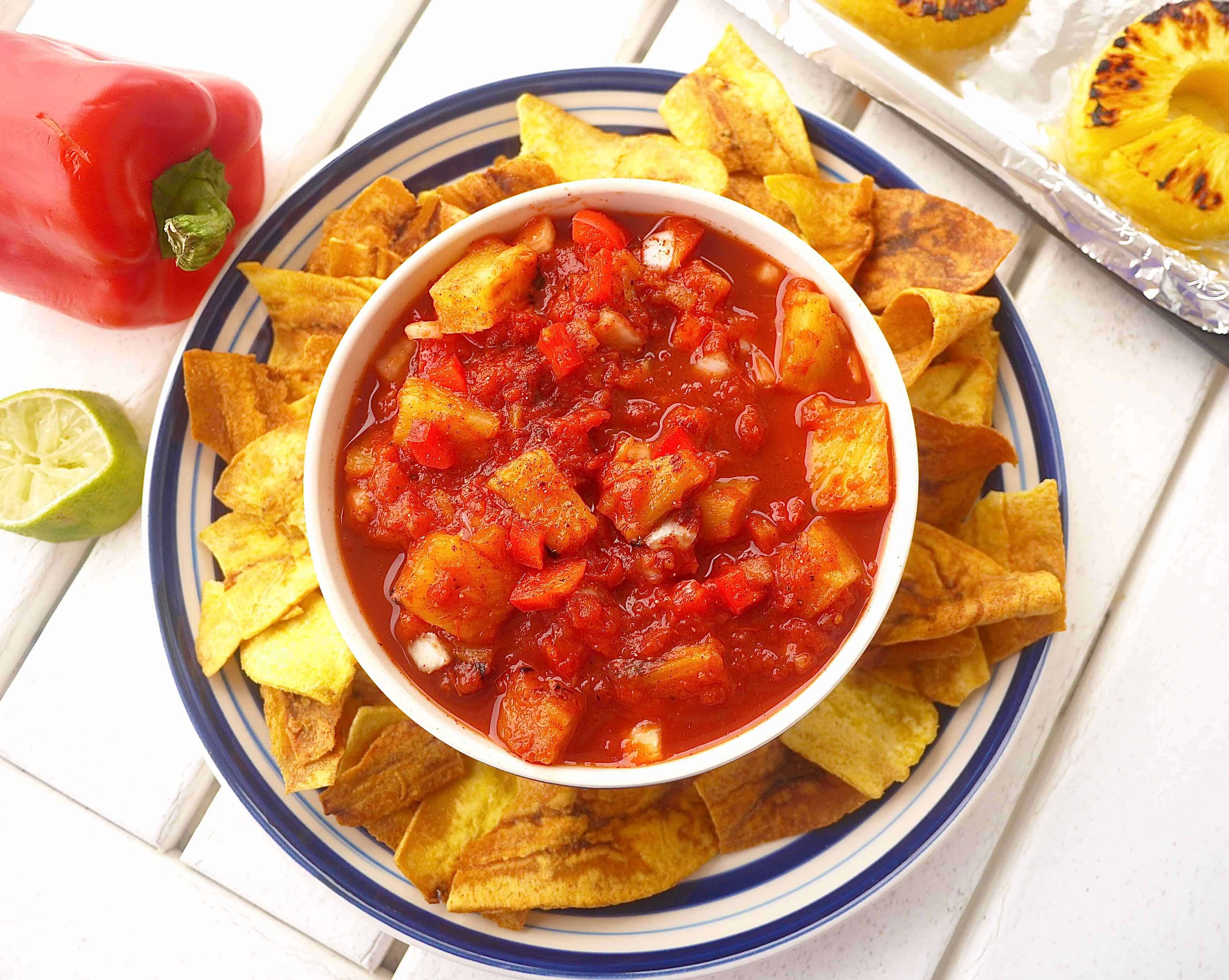Grilled Pineapple Salsa in a bowl surrounded by chips.