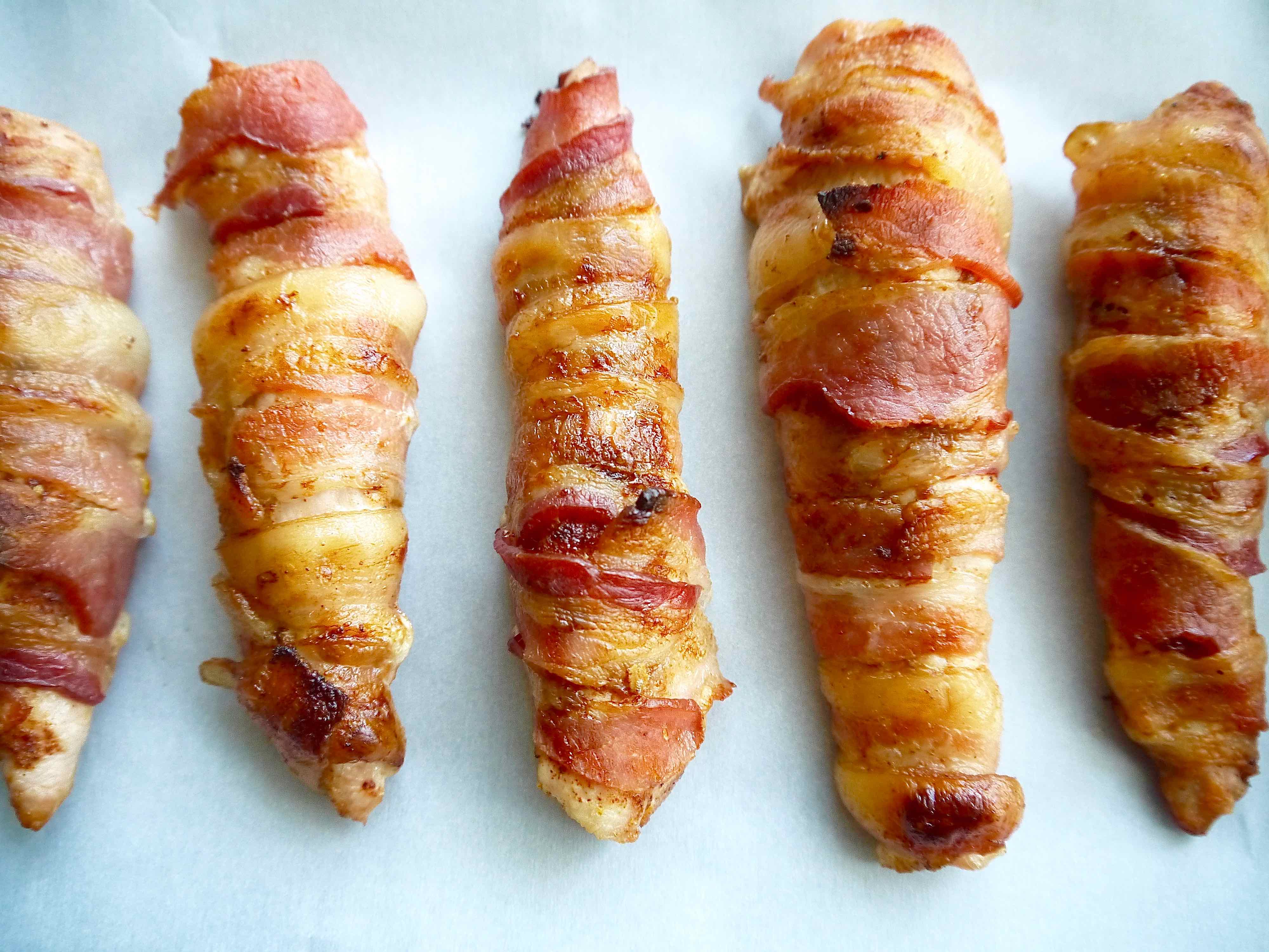 Freshly baked chicken tenders wrapped in bacon.