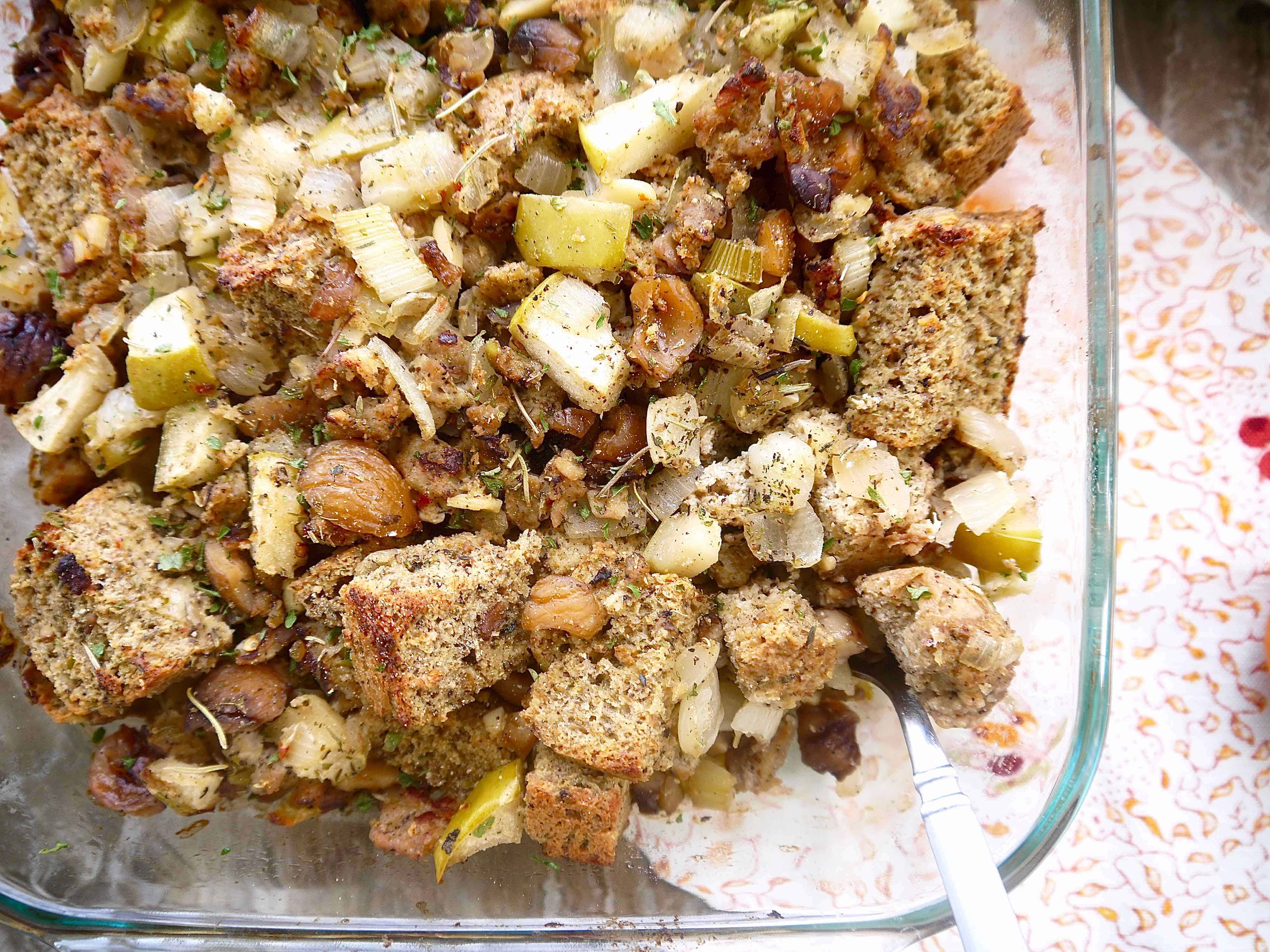 Paleo stuffing with sausage, apple, chestnut in a large baking pan.