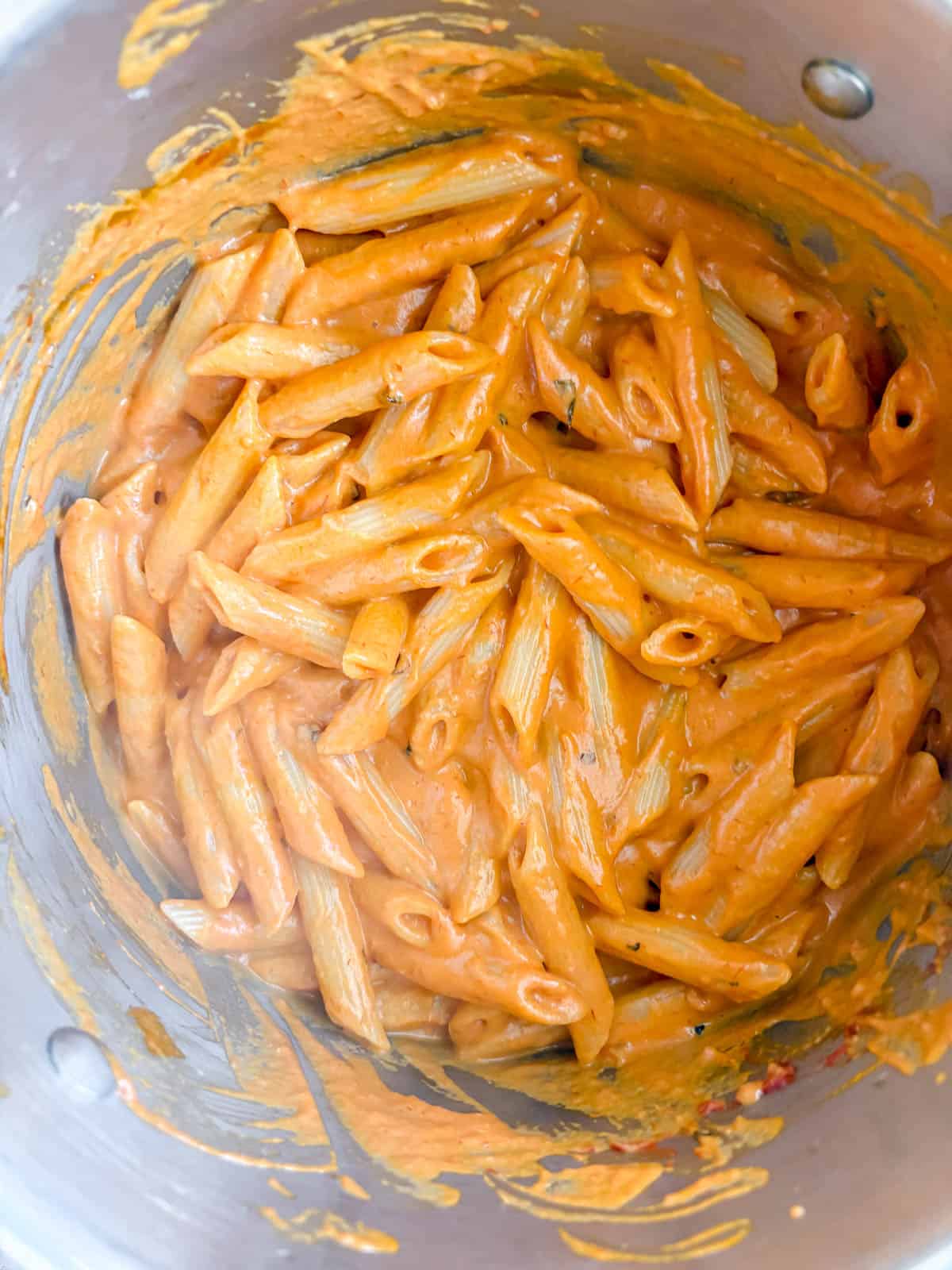 Dairy-free vodka sauce mixed into penne.