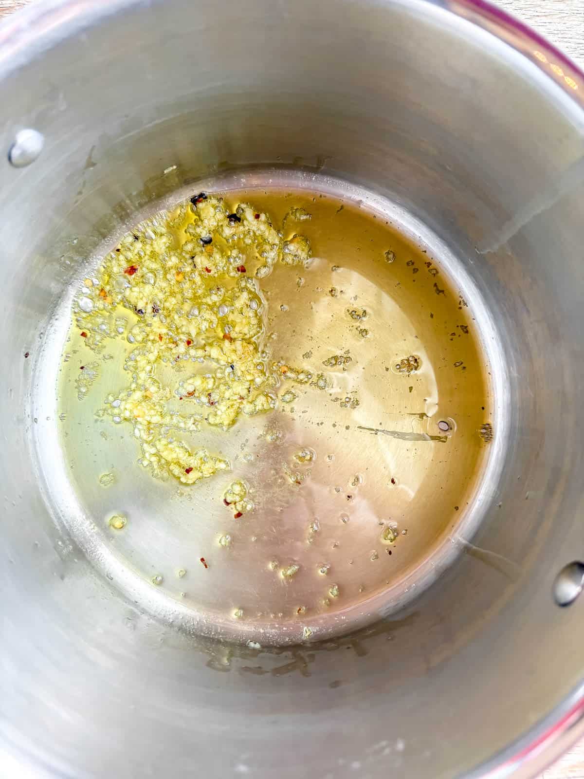 Garlic sautéing in a pan.