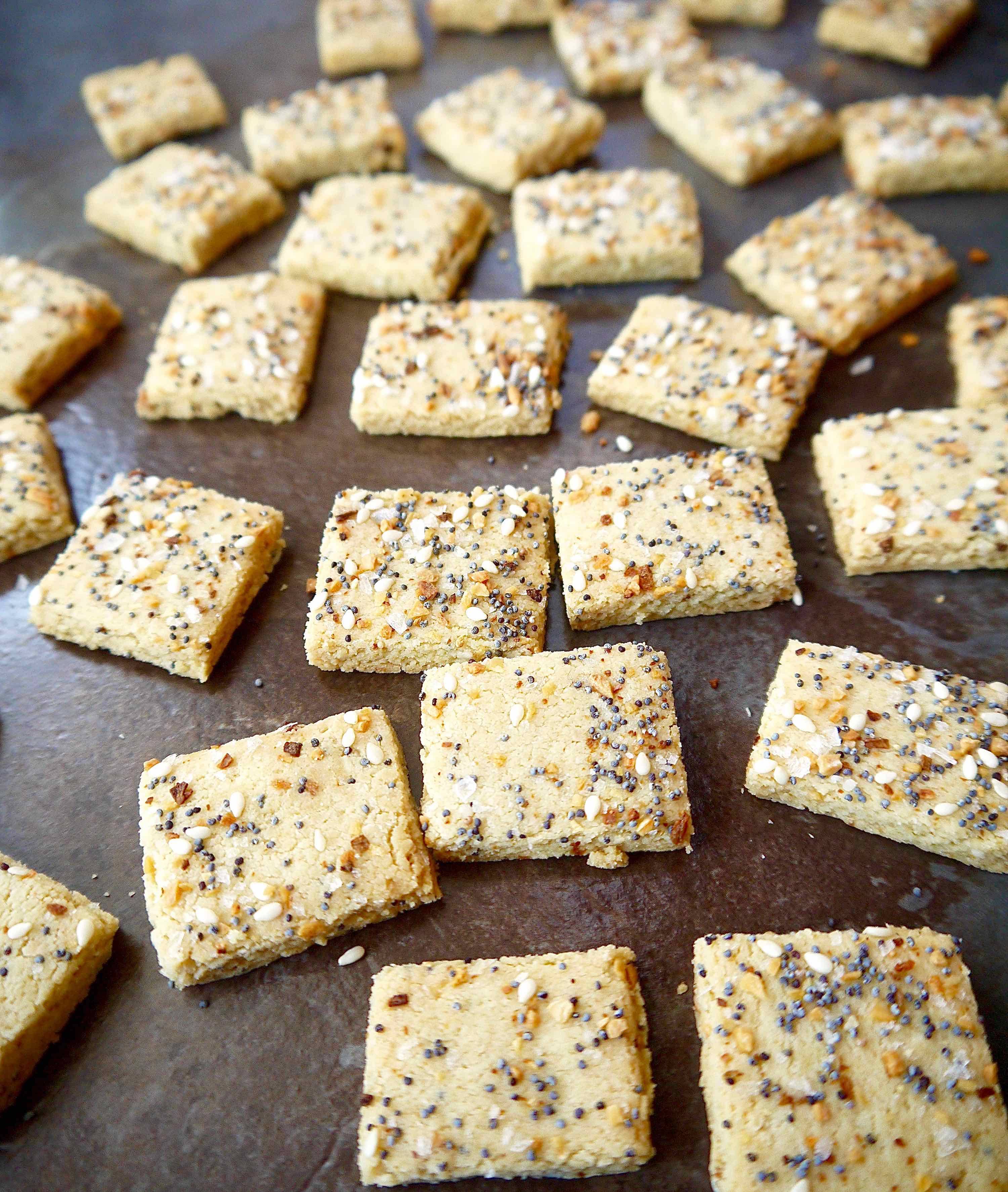 Almond flour cracker dough cut into squares after baking.