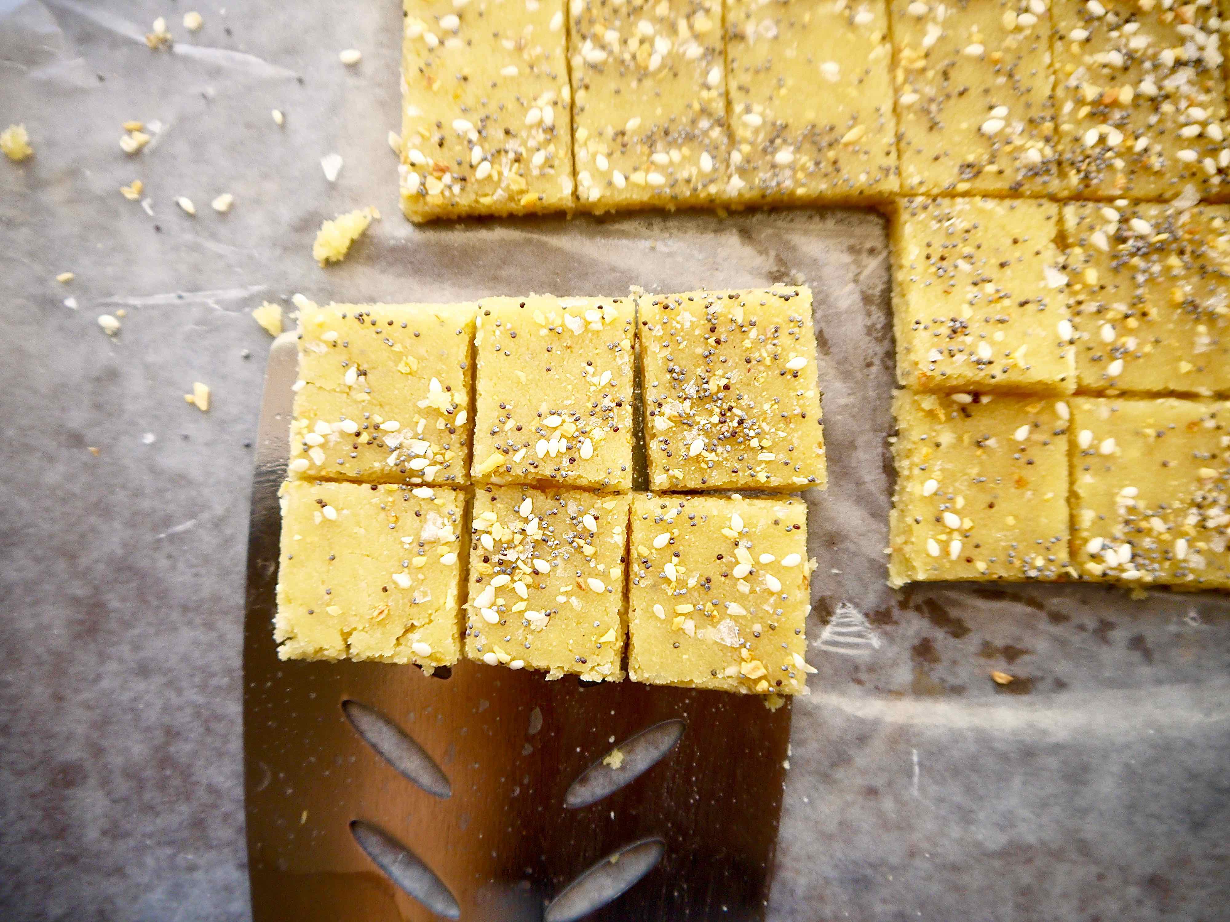 Almond flour cracker dough cut into squares before baking.