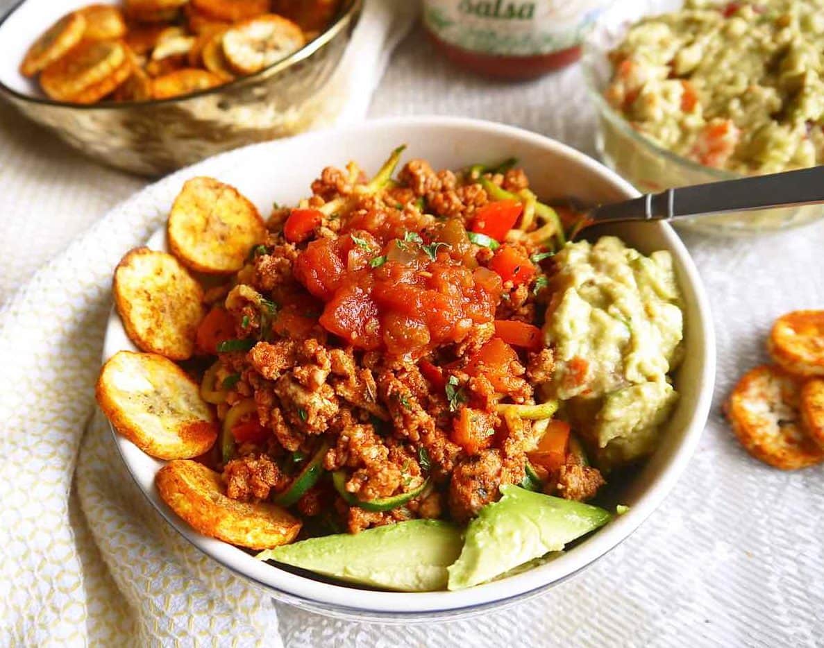 A taco bowl made of ground turkey, zoodles, and other taco sides.