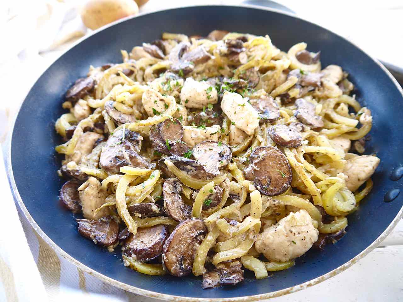 Chicken mushroom potato recipe with spiralized potatoes in a skillet.