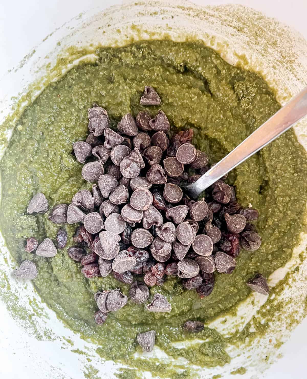 Chocolate chips and raisins added to the matcha brownie batter.