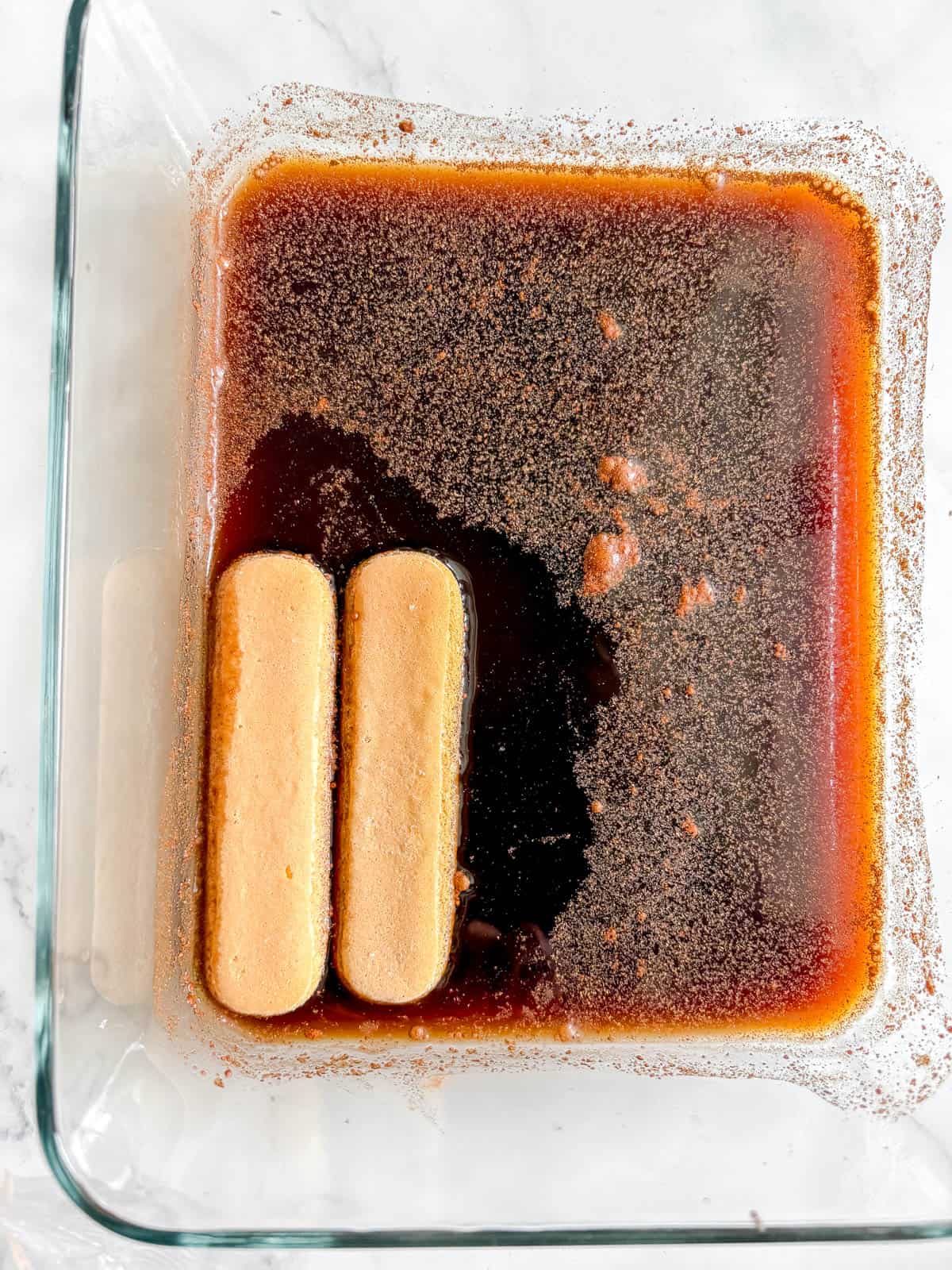 Lady fingers dunked into the coffee mixture.