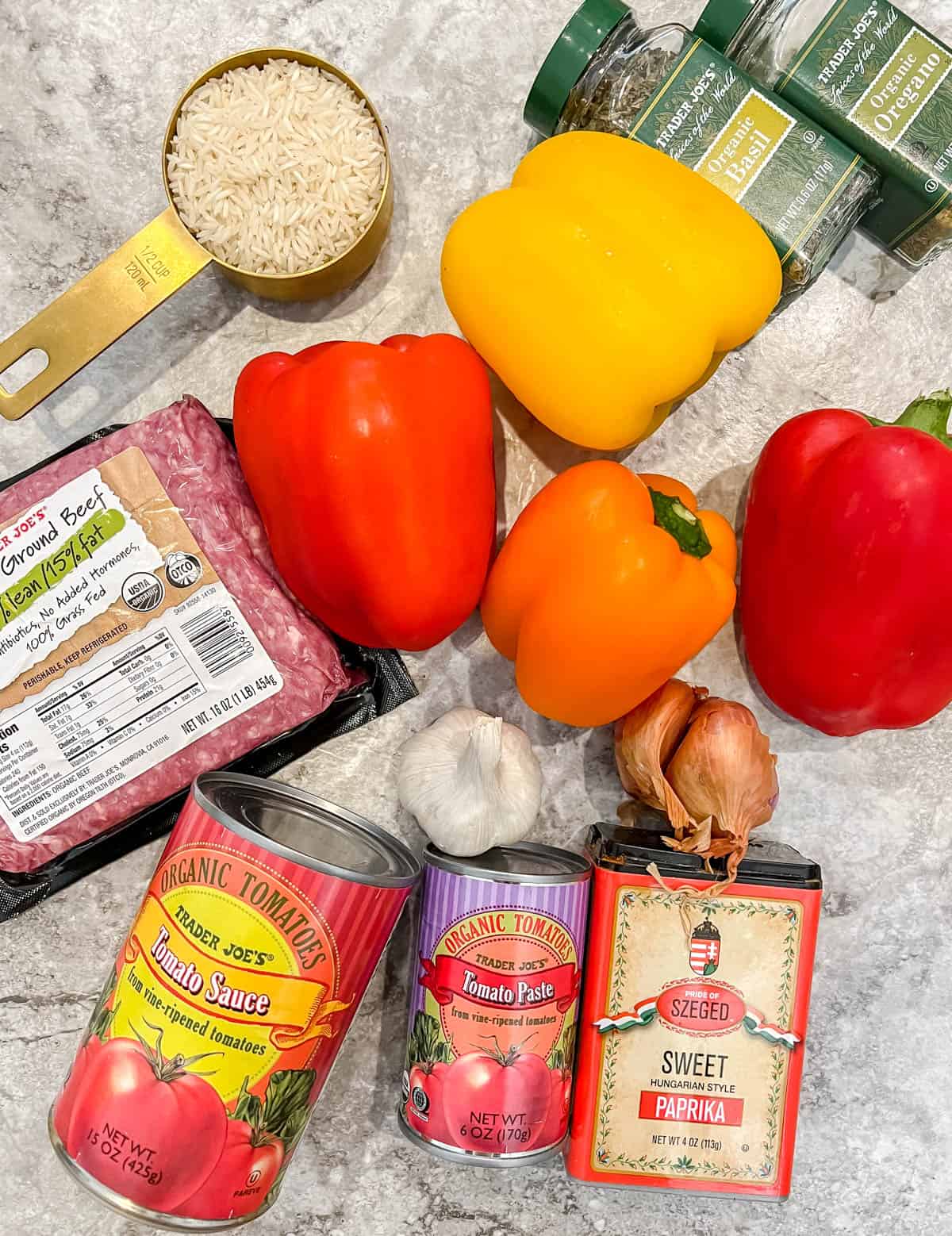 Ingredients needed to make stuffed peppers with ground beef and rice.