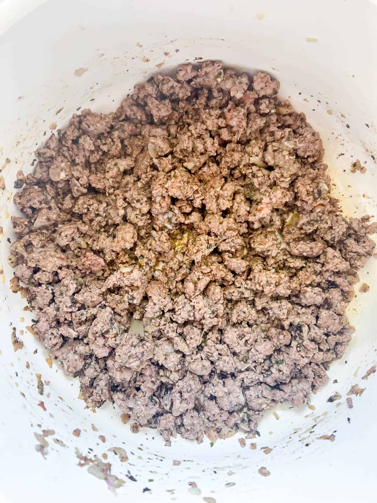 Ground beef being browned in a pan.