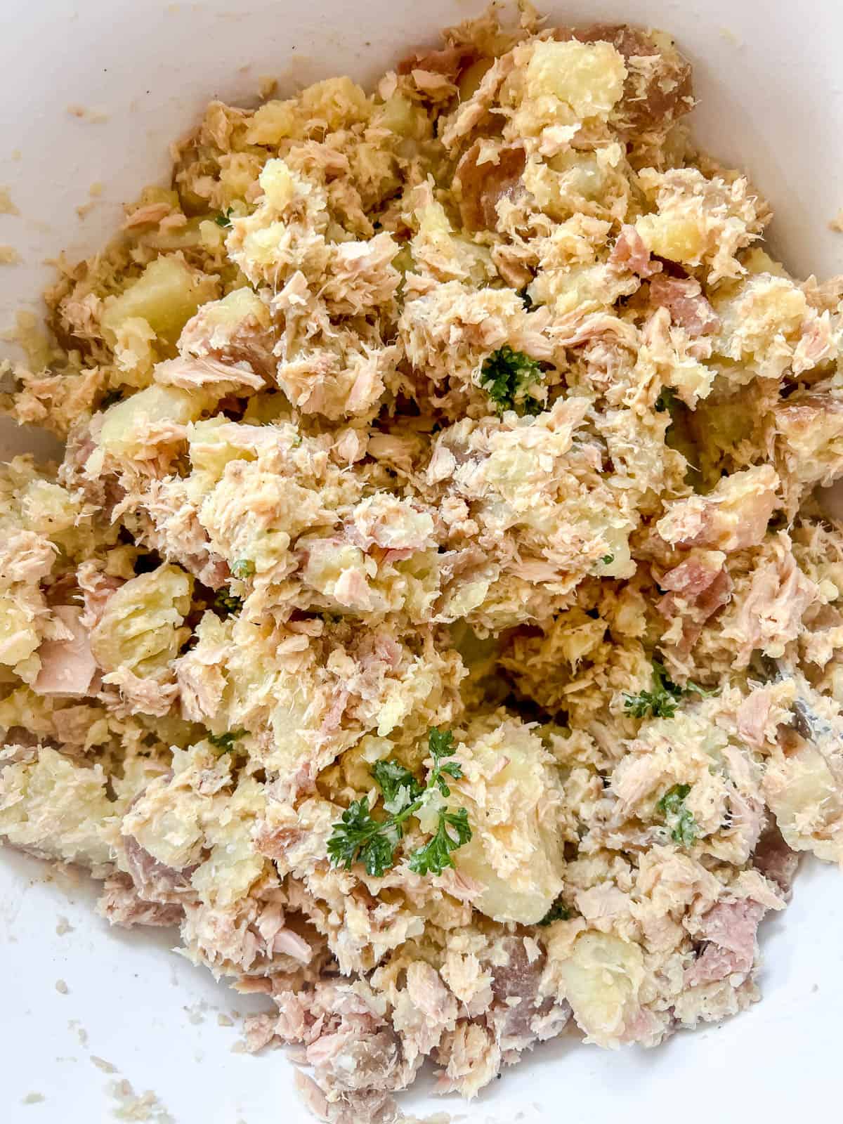 All of the ingredients for this tuna and potato salad mixed together.