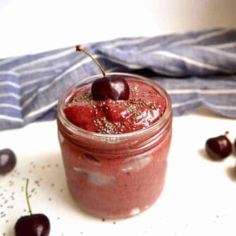 Chocolate cherry banana smoothie in a jar with chia seeds on top.