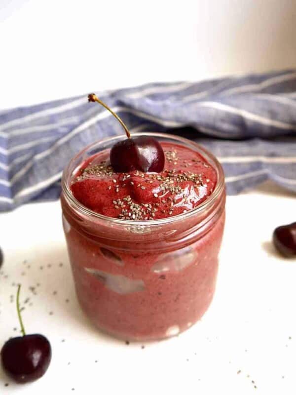 Chocolate cherry banana smoothie in a jar with chia seeds on top.