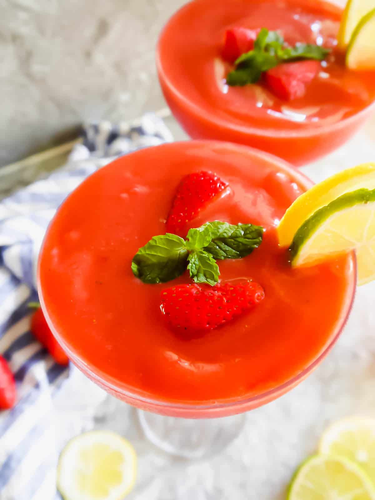 A beautiful healthy daiquiri made with strawberries in in two glasses.
