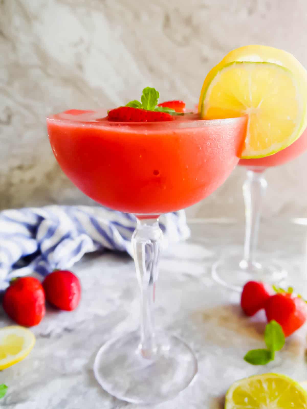 The side angle of a healthy strawberry daiquiri recipe in a cocktail glass.