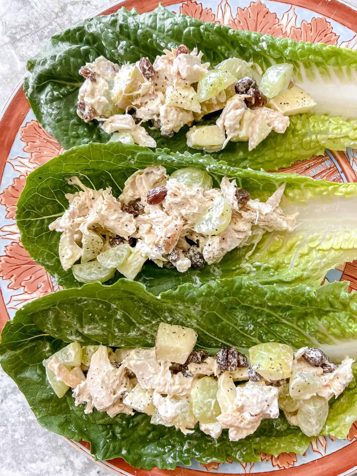 Rotisserie chicken salad on lettuce wraps on a plate.