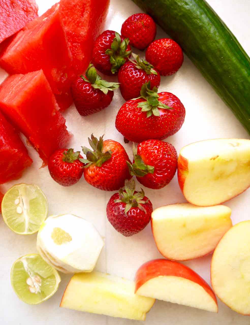 Ingredients needed to make watermelon and cucumber juice with strawberries.