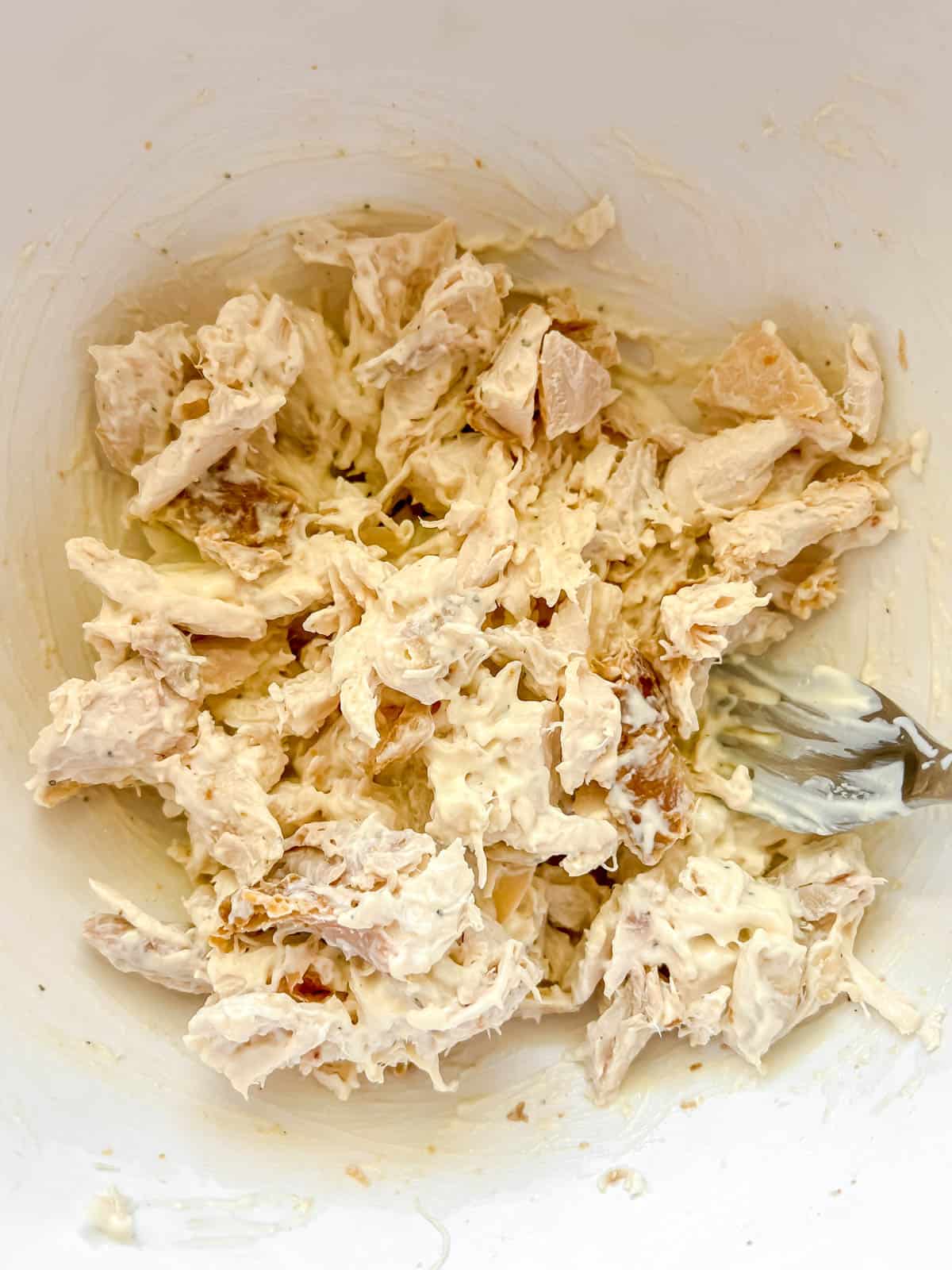 Mayo sauce mixed into chicken.