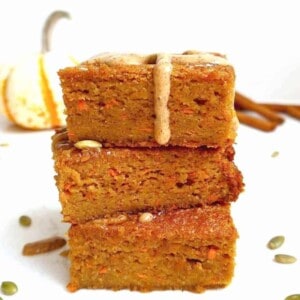 Gluten-free pumpkin carrot cake slices stacked on top of each other.