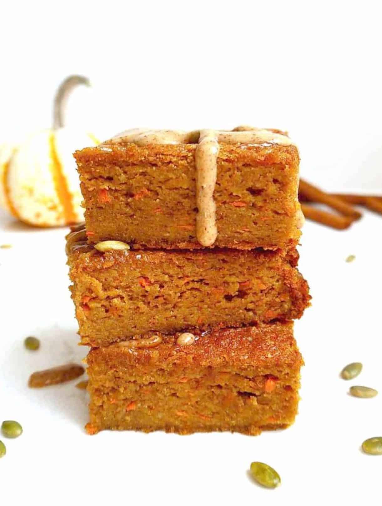 Gluten-free pumpkin carrot cake slices stacked on top of each other.
