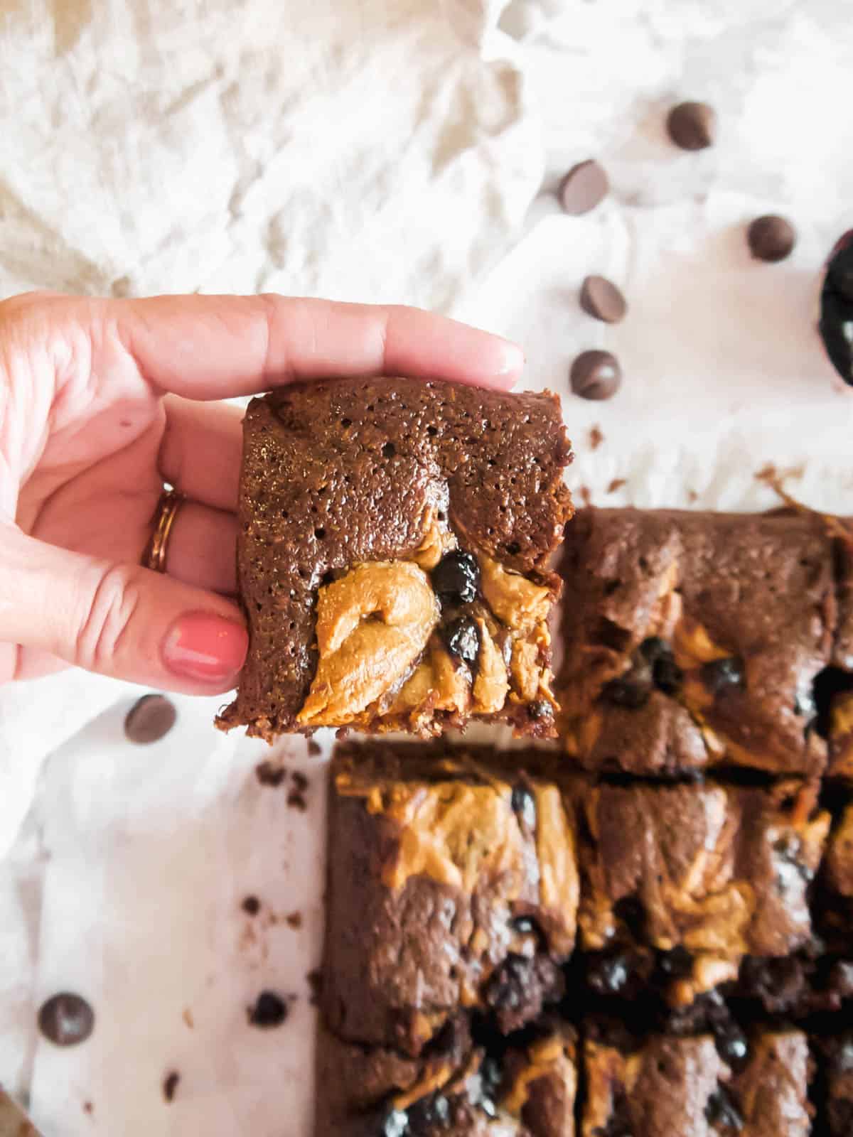Lifting up a slice of the best Paleo brownies!