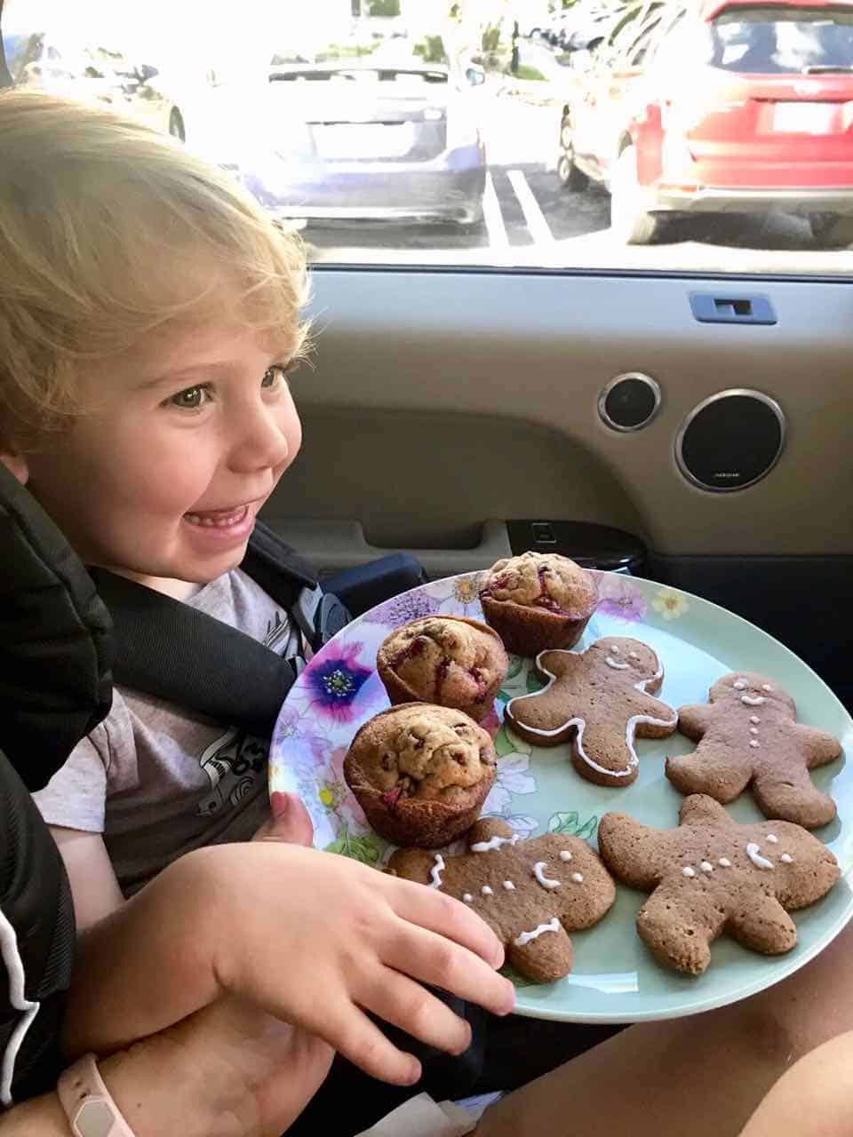 Toddler enjoying gingerbread men cookies.