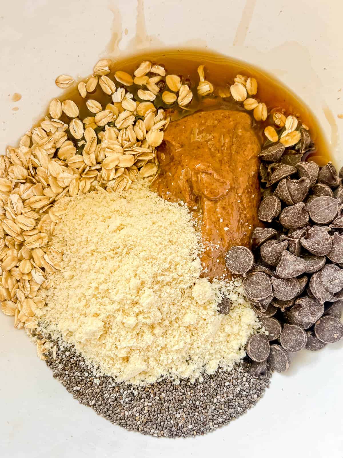 All the energy ball ingredients added to a bowl.