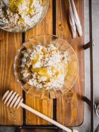 Gluten free steel cut oats recipe in a bowl with honey and chia seeds on top.