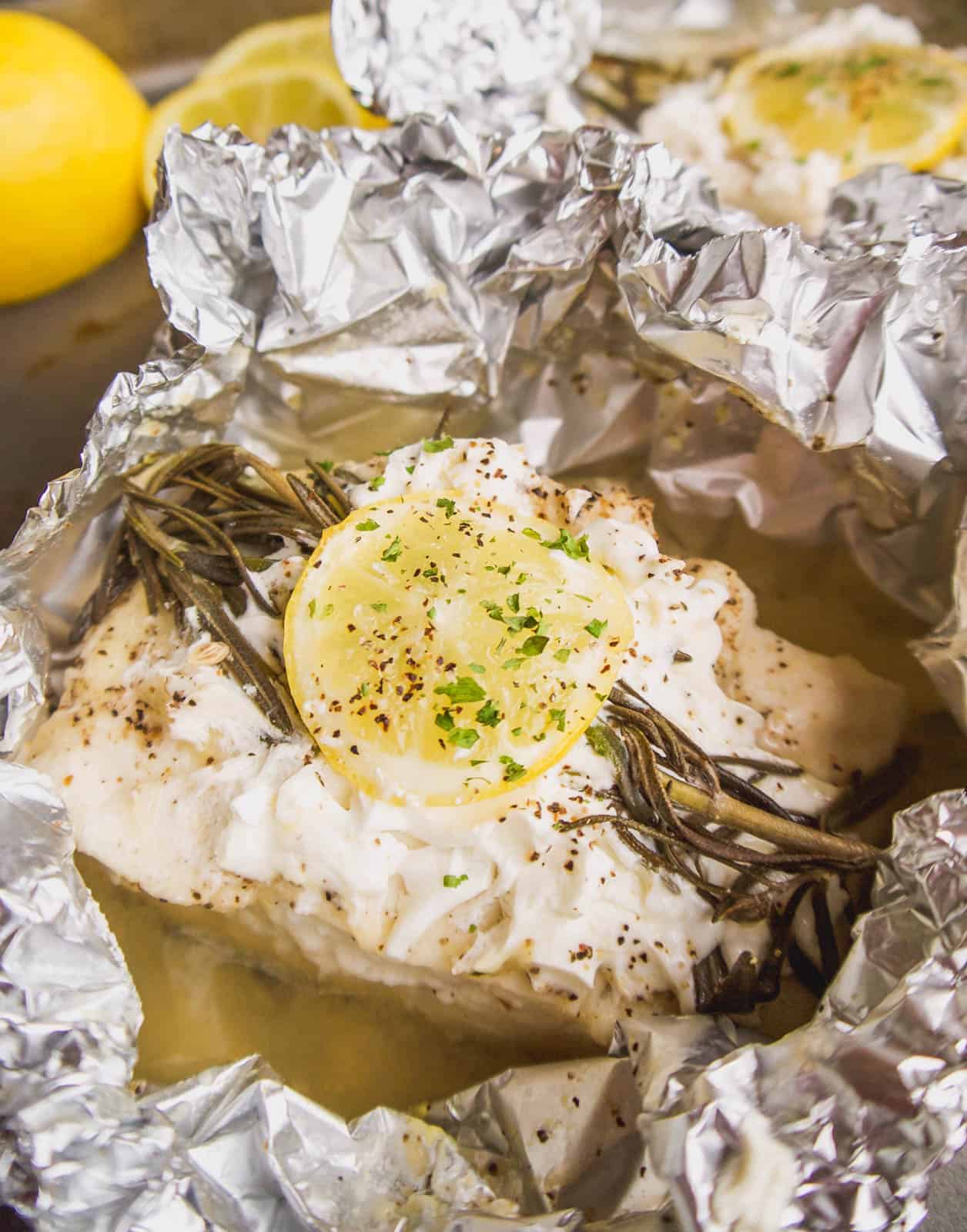 Foil packet lemon rosemary halibut with a side of rice.