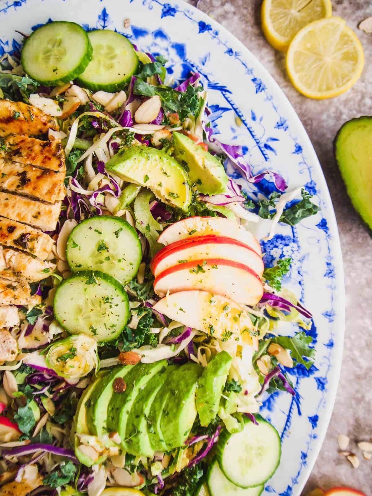A close up shot of a cruciferous vegetable salad on a blue plate.