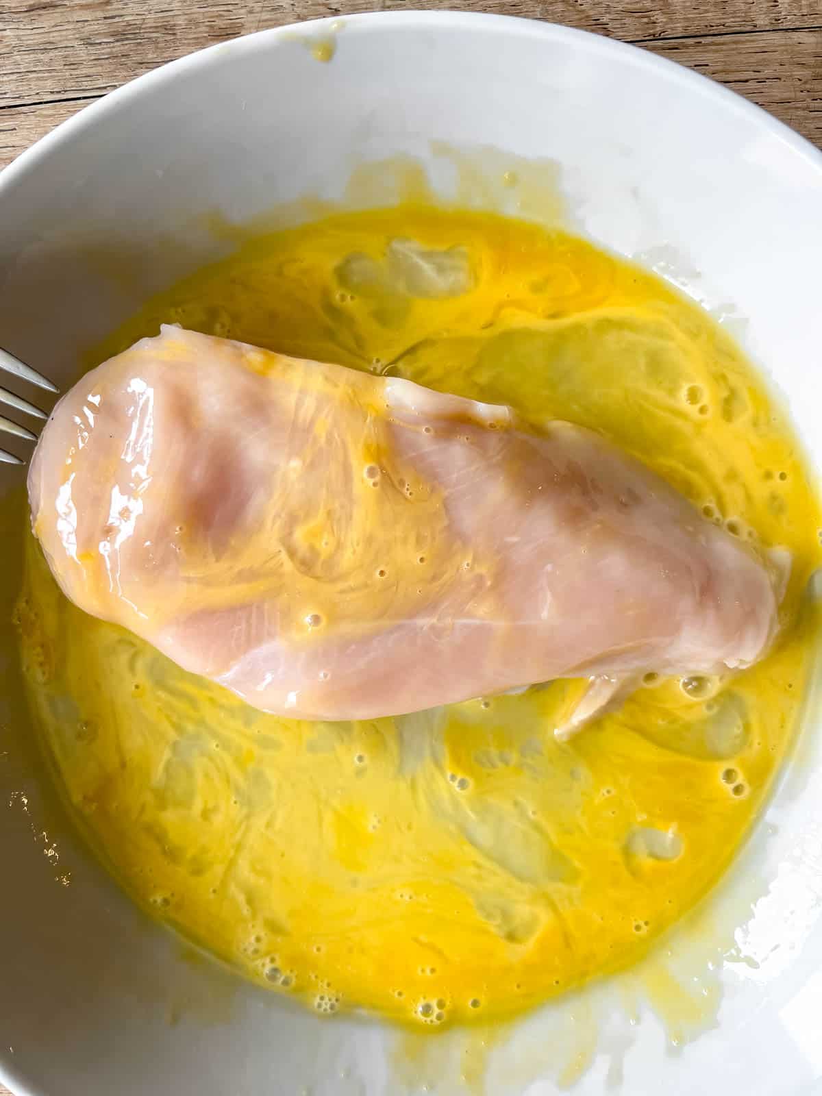 Chicken breast dunked in egg.