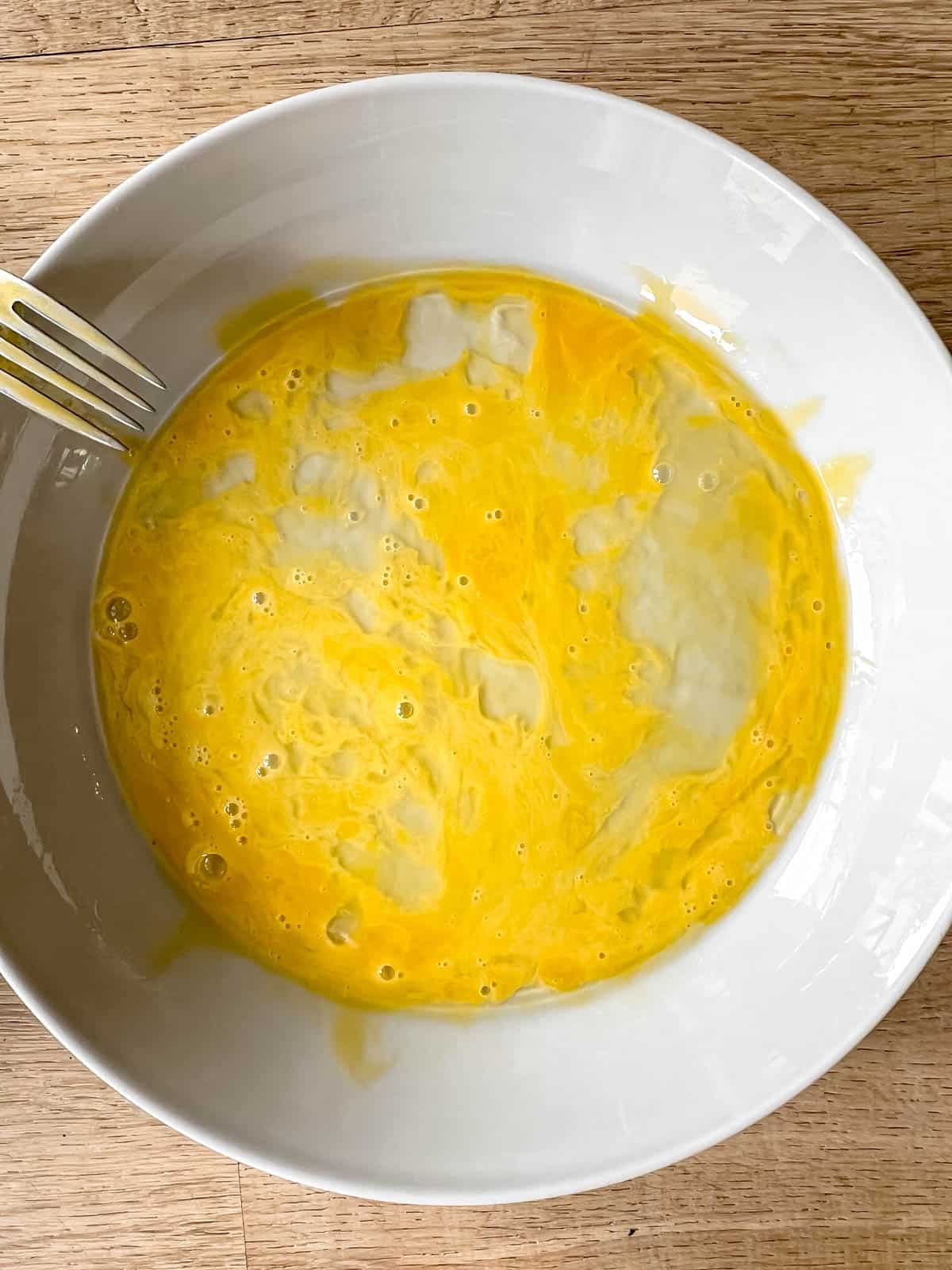 Mixed eggs in a bowl.