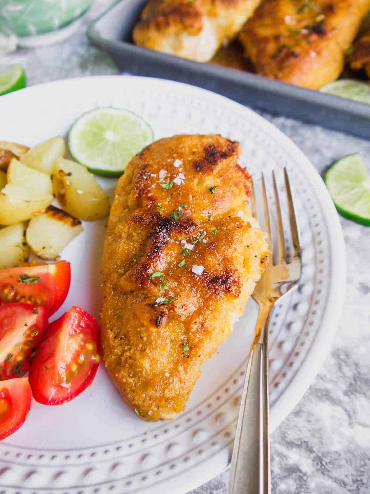 Almond flour breaded chicken with maple lime sauce on a plate.