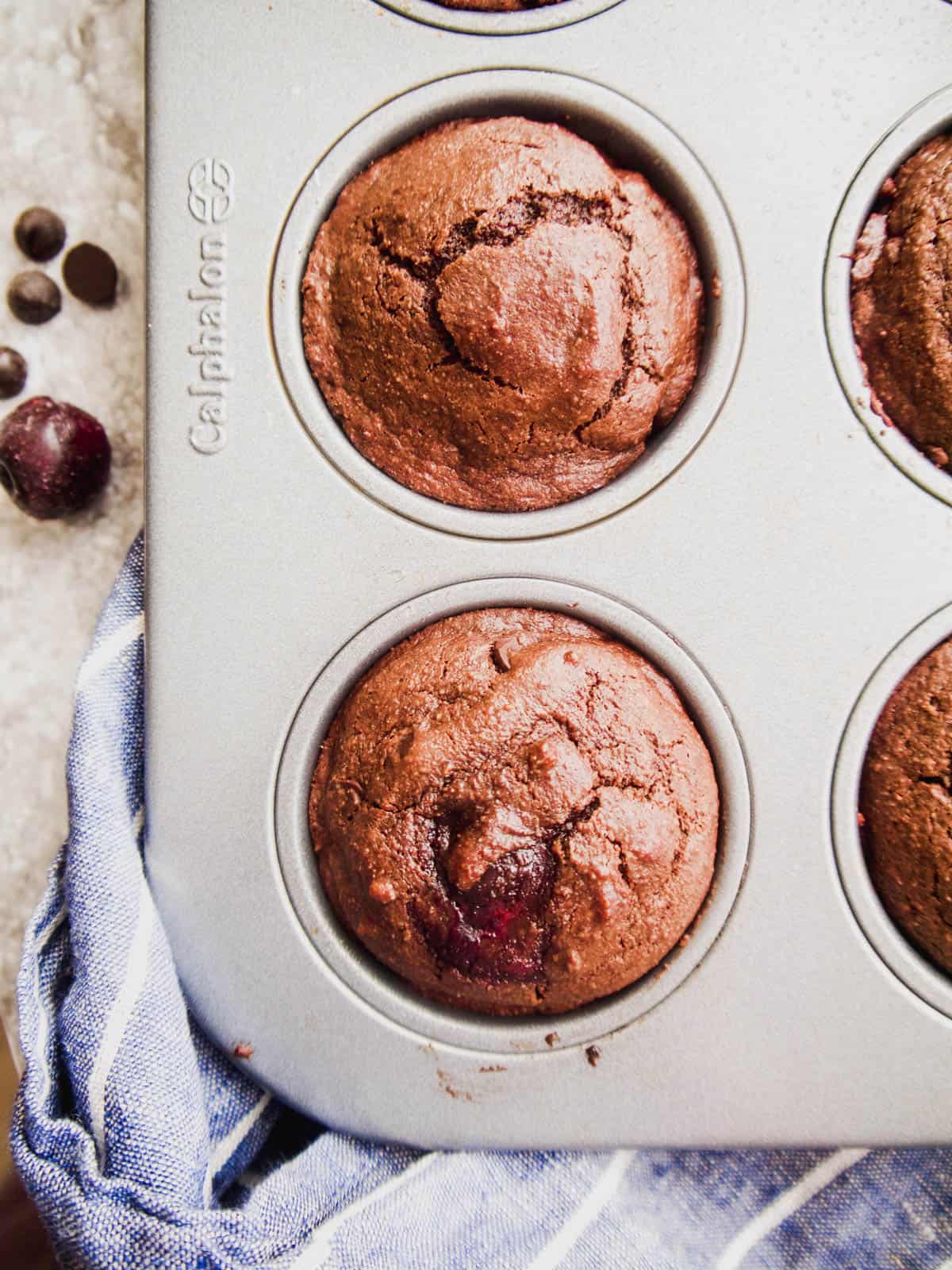 Chocolate paleo muffins with cherries in a loaf tin.