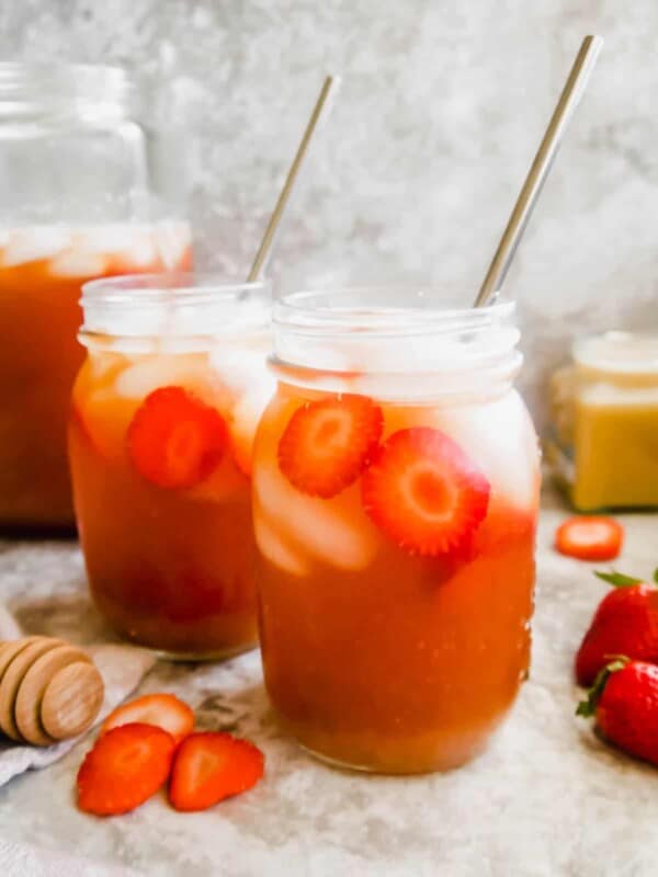 Strawberry Sweet Tea in mason jars with straws in them.